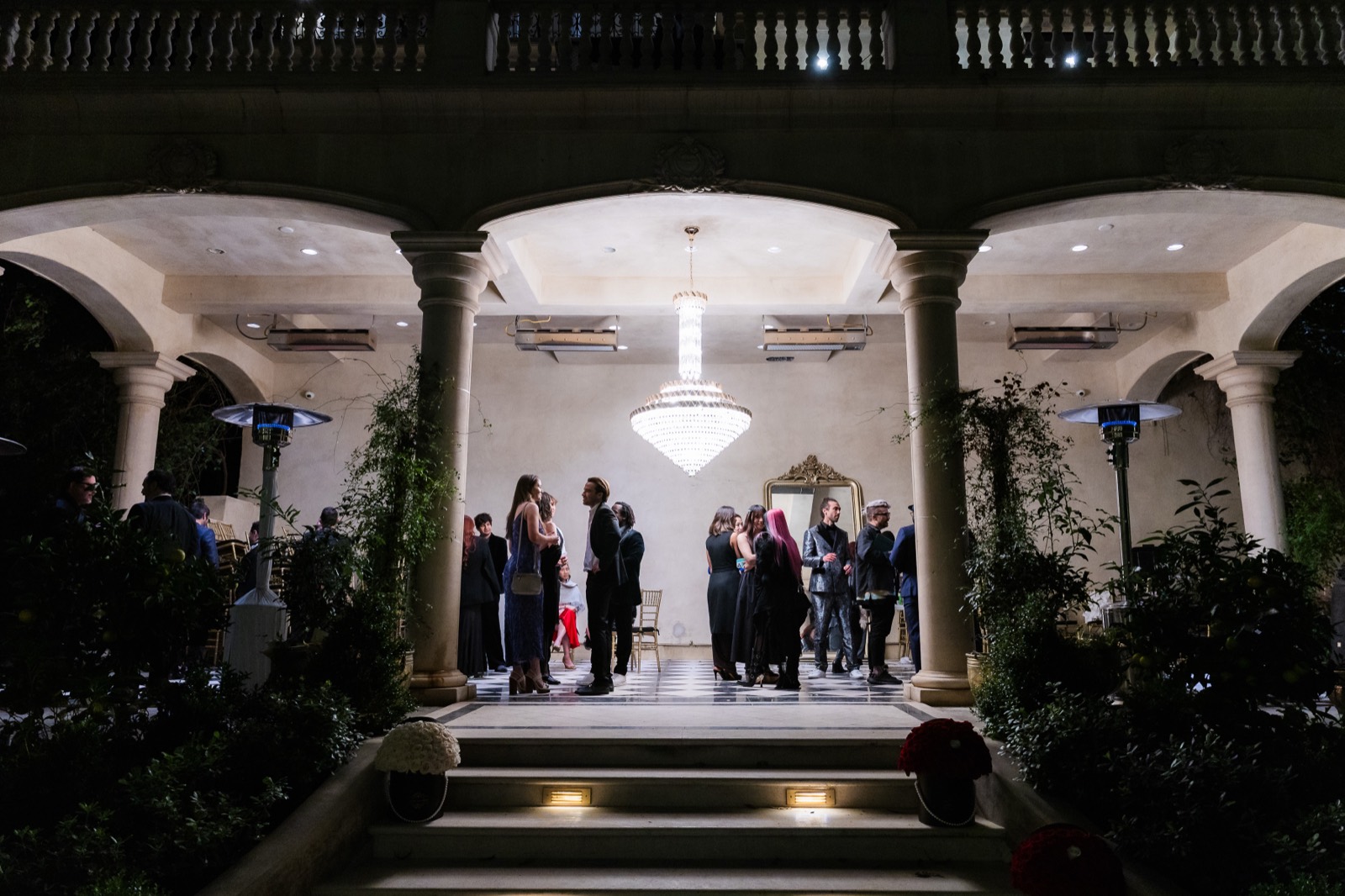 Guests beneath the chandelier on the estate's colonnade