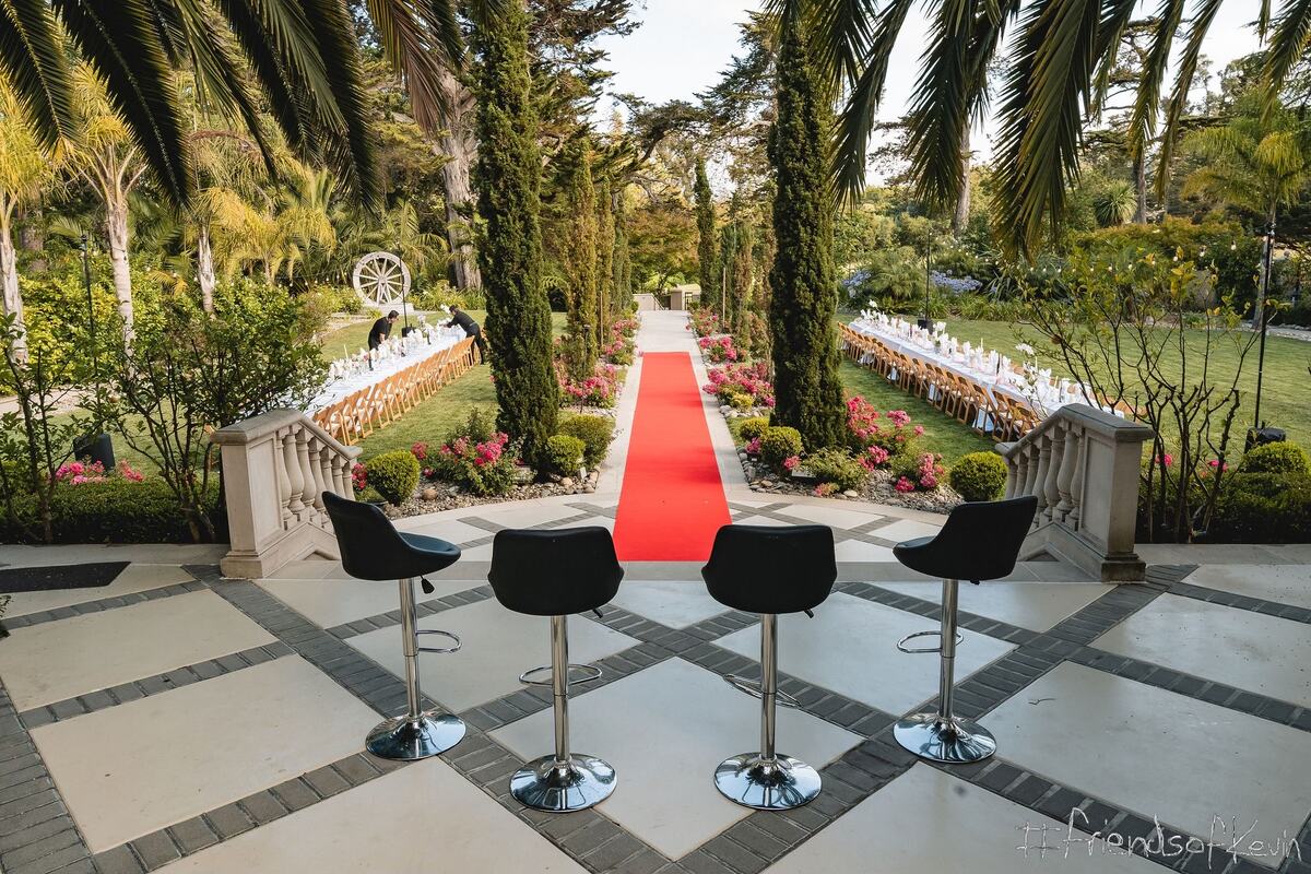 Bar stools set out on the terrace before the red carpet