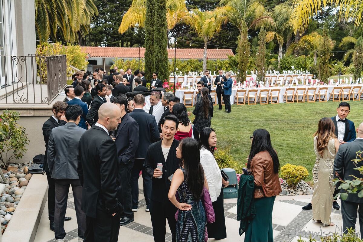 Guests mingling on the terrace above the lawn