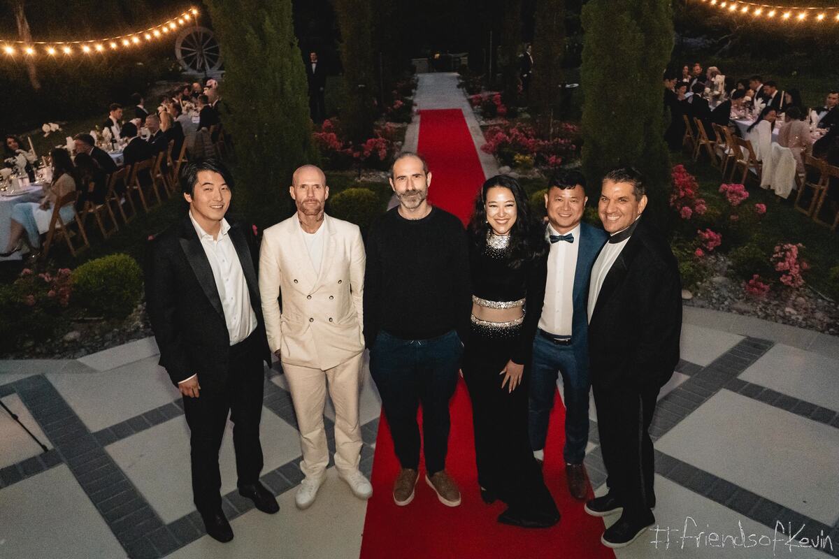 Guests together on the red carpet at night